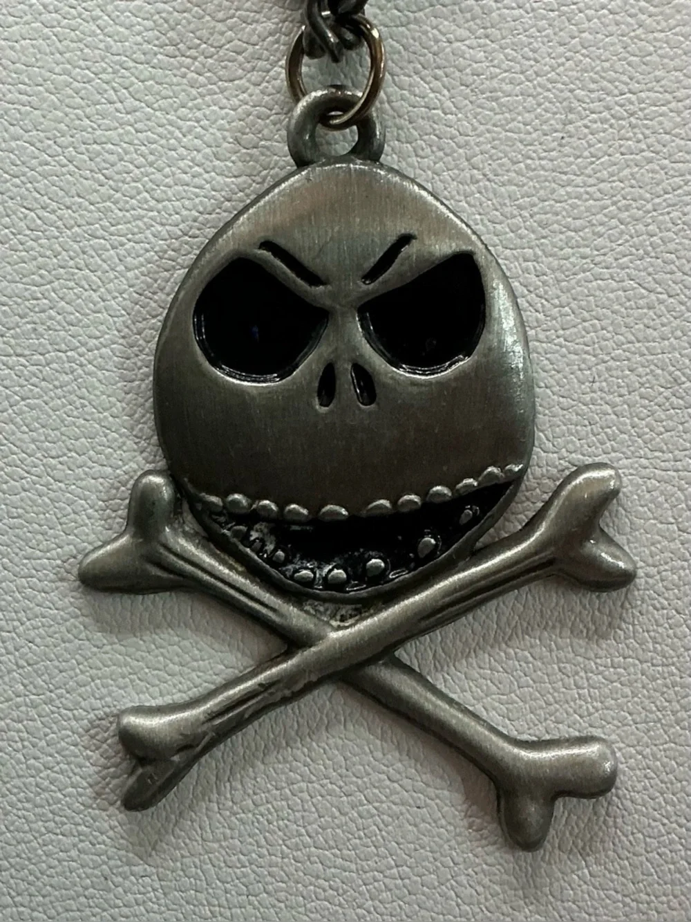 DISNEY JACK SKELINGTON SKULL AND CROSSBONES OEWTER TONE PENDANT NECKLACE